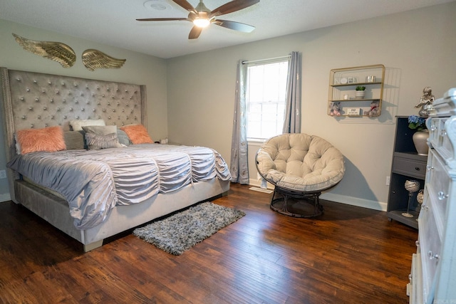 bedroom with dark hardwood / wood-style flooring and ceiling fan