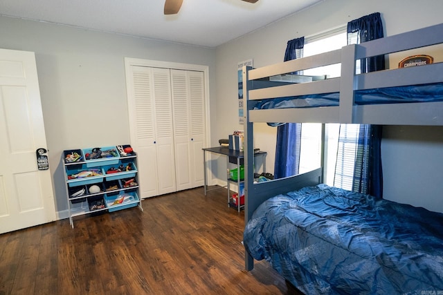 bedroom with ceiling fan, multiple windows, dark hardwood / wood-style flooring, and a closet