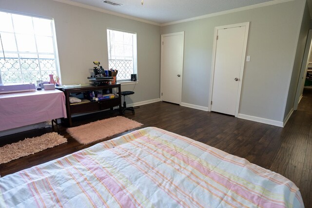 bedroom featuring ornamental molding and dark hardwood / wood-style flooring