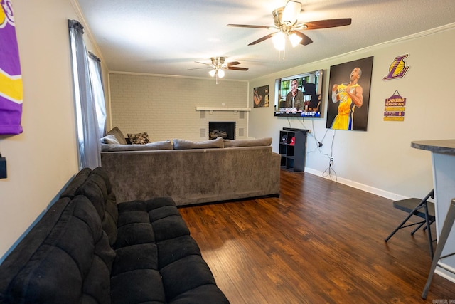 living room featuring brick wall, ornamental molding, a fireplace, and dark wood-type flooring