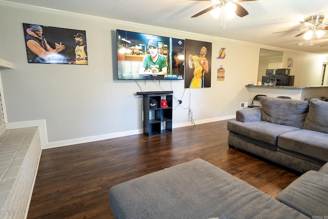 living room with crown molding, dark wood-type flooring, a textured ceiling, and ceiling fan