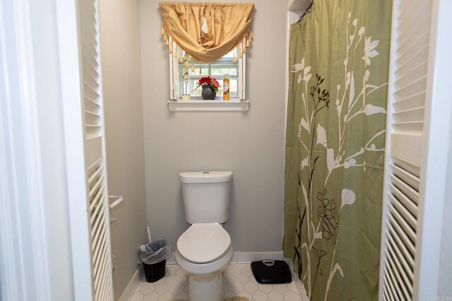 bathroom featuring tile patterned flooring and toilet