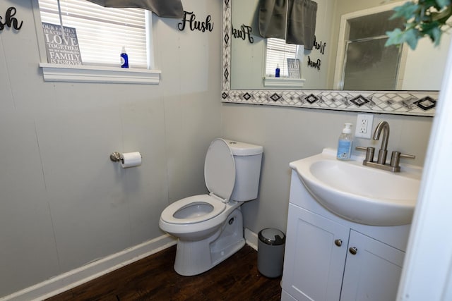 bathroom with hardwood / wood-style flooring, vanity, and toilet