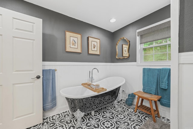 bathroom featuring tile patterned flooring and a tub