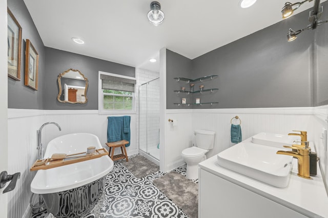 bathroom with tile patterned floors, walk in shower, dual bowl vanity, and toilet