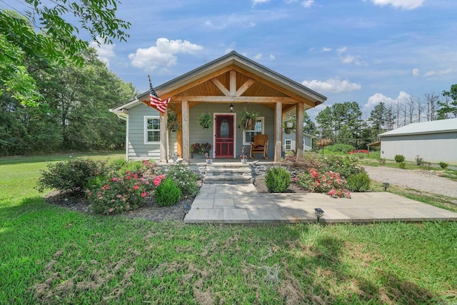 bungalow-style house with a porch and a front yard