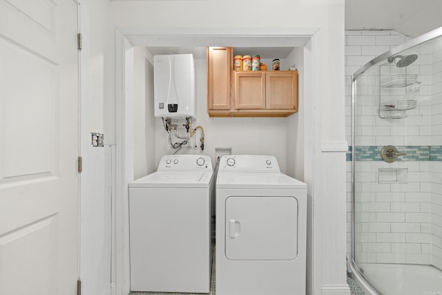 laundry room with tankless water heater, cabinets, and separate washer and dryer