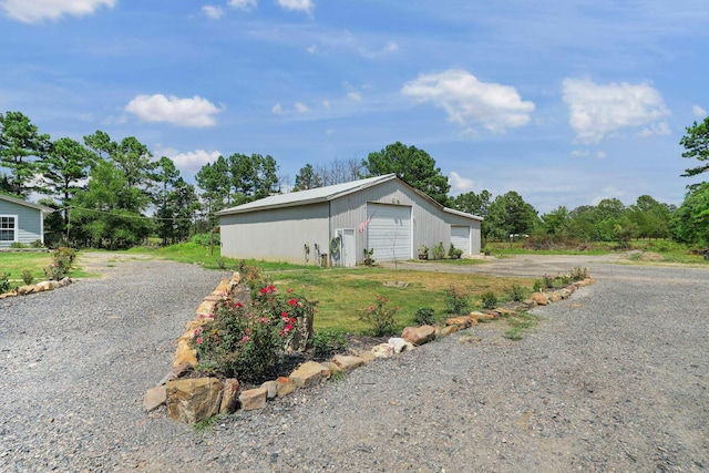 view of property exterior featuring an outdoor structure and a garage