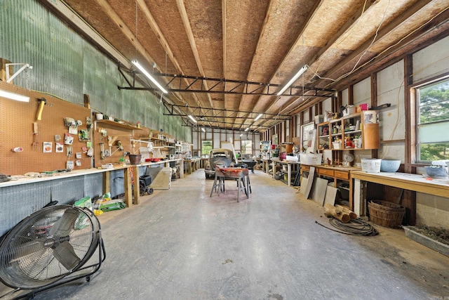 misc room with concrete floors and a workshop area