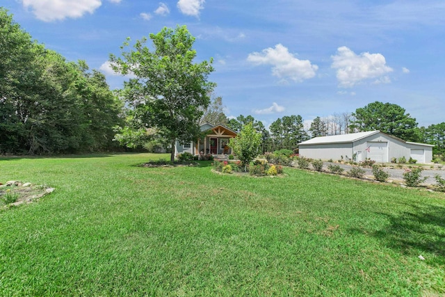 2911 Polk Rd 54, Mena, AR 71953 - view of grassy yard with a garage