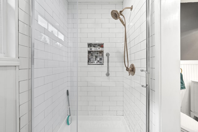 bathroom with a shower with shower door and toilet