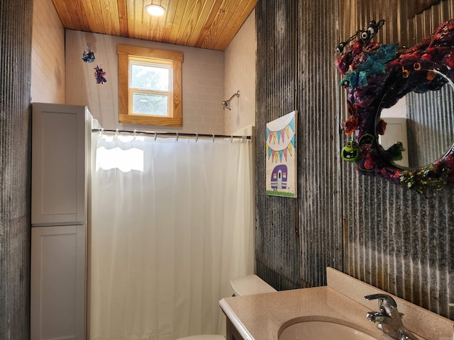 bathroom with vanity, wooden ceiling, and toilet