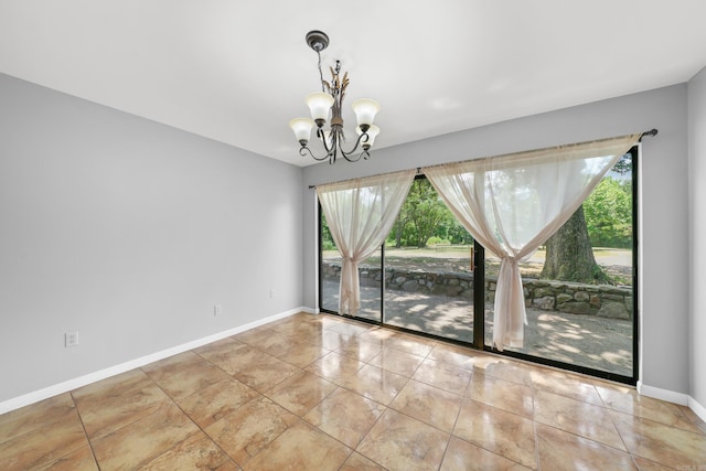 unfurnished room with a notable chandelier and light tile patterned floors