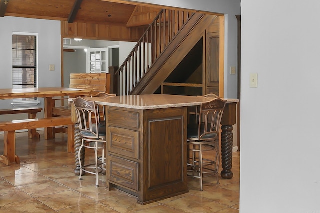 bar featuring light tile patterned flooring, light stone countertops, beam ceiling, and wooden ceiling