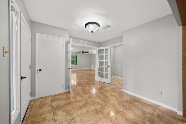 spare room with light tile patterned flooring, ceiling fan, and french doors