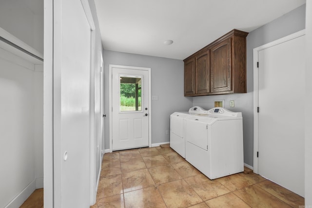 washroom featuring cabinets, washer and dryer, and light tile patterned floors