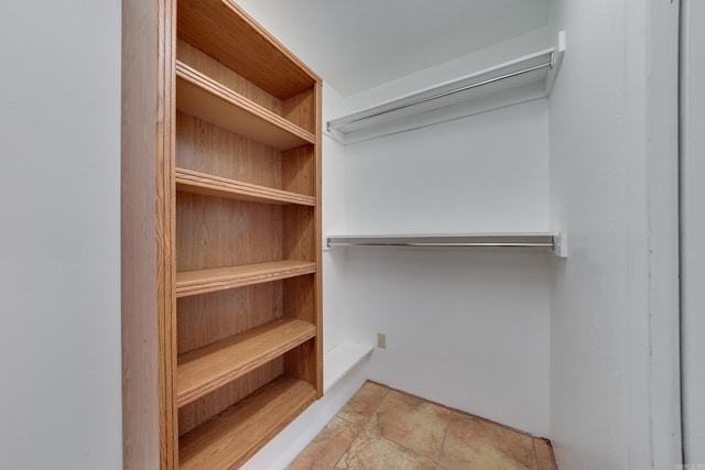 spacious closet with light tile patterned flooring