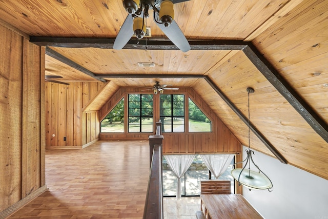 additional living space featuring vaulted ceiling with beams, wooden ceiling, ceiling fan, and wood-type flooring