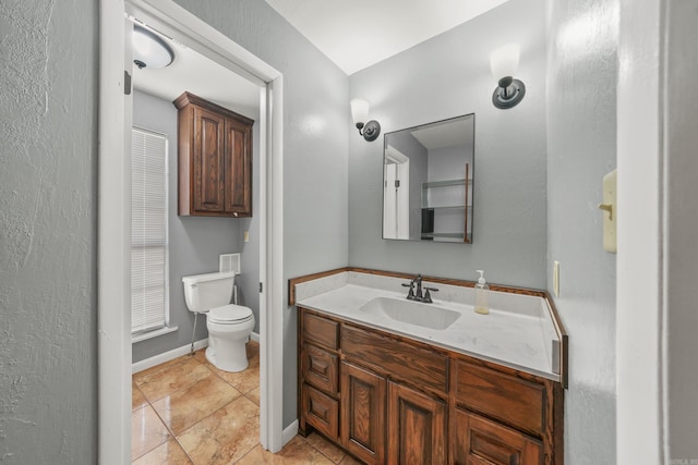 bathroom with tile patterned flooring, toilet, and vanity