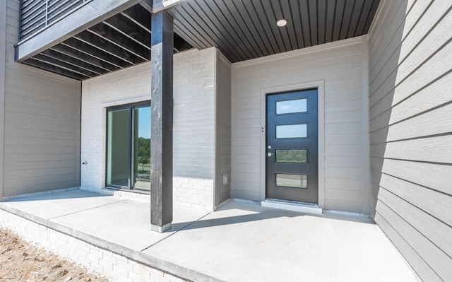 property entrance with a patio