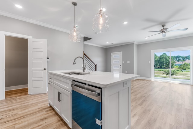 kitchen featuring decorative light fixtures, sink, white cabinets, stainless steel dishwasher, and a center island with sink