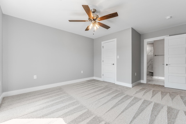 unfurnished bedroom featuring ensuite bathroom, light carpet, and ceiling fan