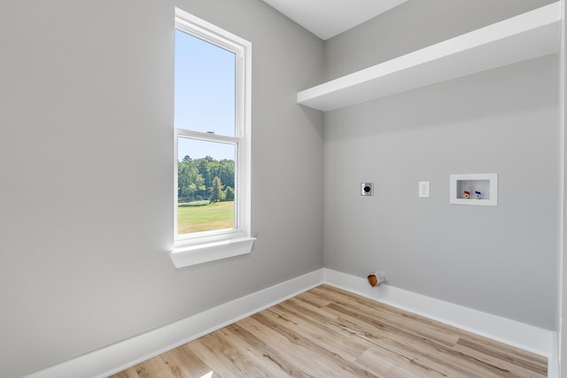 laundry area with hookup for a washing machine, light hardwood / wood-style floors, and hookup for an electric dryer