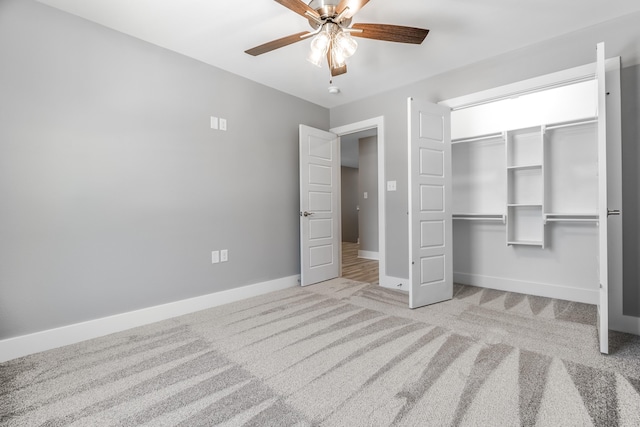 unfurnished bedroom with light colored carpet, a closet, and ceiling fan