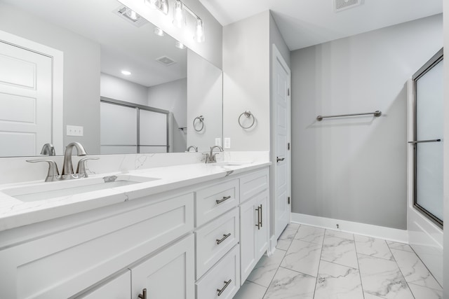 bathroom featuring vanity and combined bath / shower with glass door