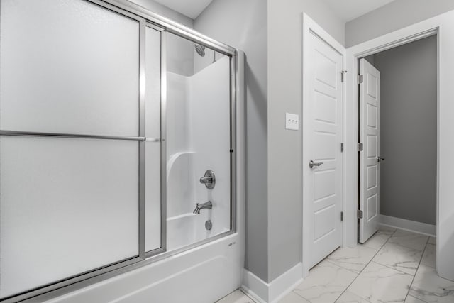 bathroom featuring bath / shower combo with glass door