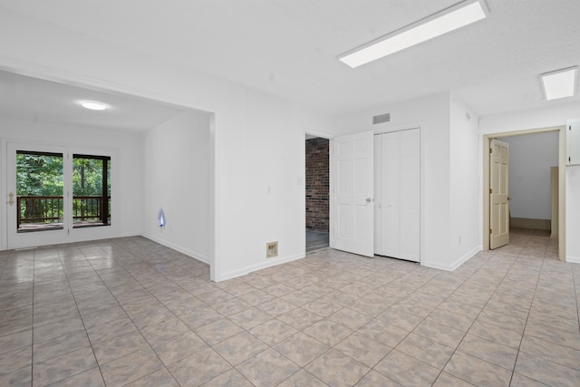 empty room with light tile patterned floors