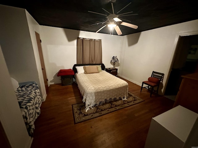 bedroom with ceiling fan and dark hardwood / wood-style flooring