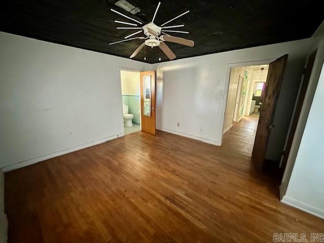 unfurnished room featuring ceiling fan and hardwood / wood-style floors