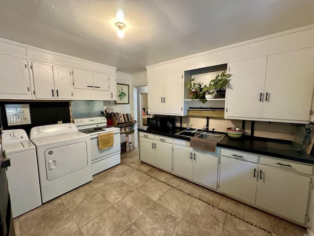 kitchen featuring a textured ceiling, washing machine and clothes dryer, white cabinets, sink, and electric range