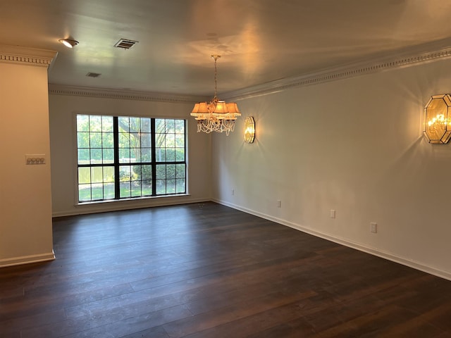 unfurnished room featuring ornamental molding, dark hardwood / wood-style floors, and a chandelier