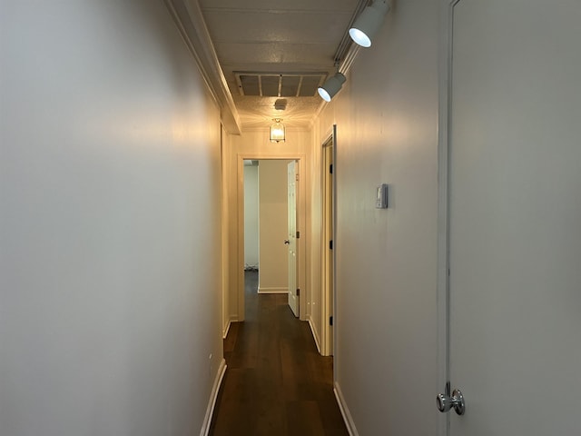 hall featuring ornamental molding and dark hardwood / wood-style floors