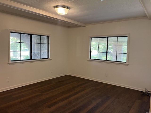 empty room featuring crown molding, beam ceiling, and dark wood-type flooring