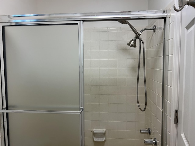 bathroom with shower / bath combination with glass door