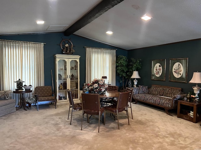 carpeted dining space featuring lofted ceiling with beams