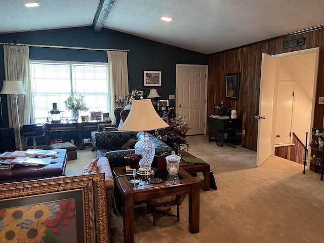 living room with carpet flooring, vaulted ceiling with beams, a textured ceiling, and wood walls