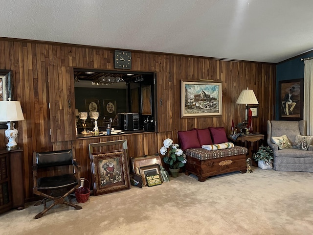 living room with carpet flooring, wooden walls, and a textured ceiling