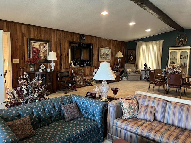 living room with carpet floors, lofted ceiling with beams, a textured ceiling, and wood walls