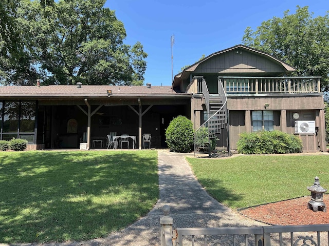 exterior space with a front lawn and ac unit