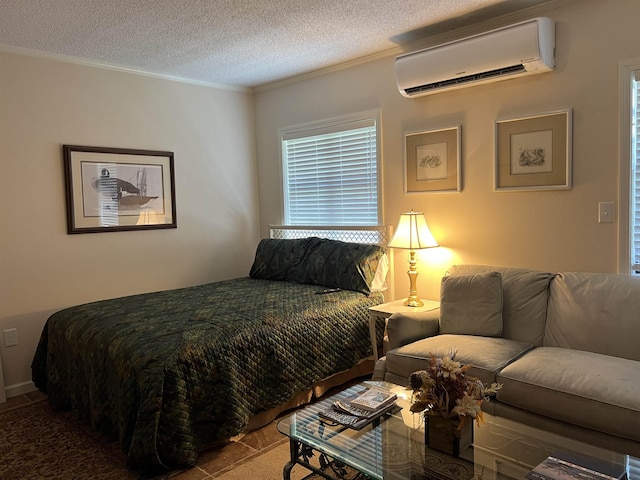 bedroom with ornamental molding, an AC wall unit, and a textured ceiling