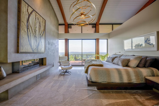 bedroom featuring access to exterior, a multi sided fireplace, a mountain view, high vaulted ceiling, and beamed ceiling