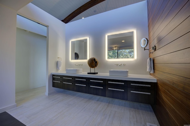 bathroom featuring vanity, lofted ceiling with beams, wooden ceiling, and wooden walls