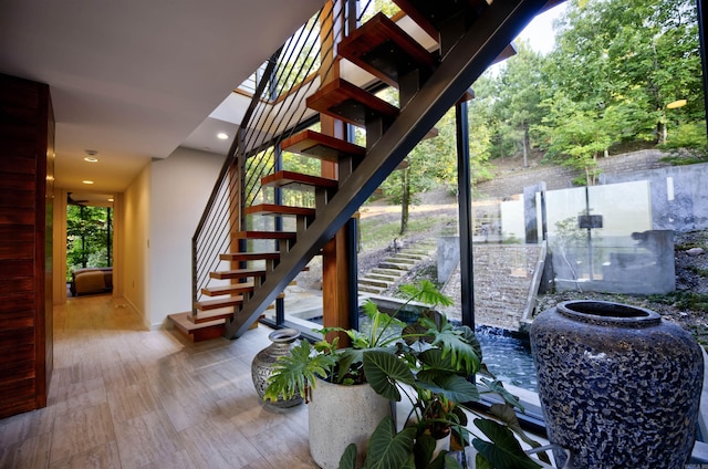 stairs featuring hardwood / wood-style floors