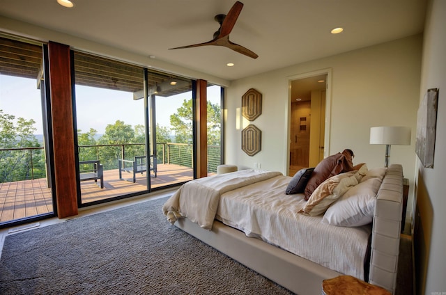 bedroom featuring ceiling fan, a wall of windows, and access to outside