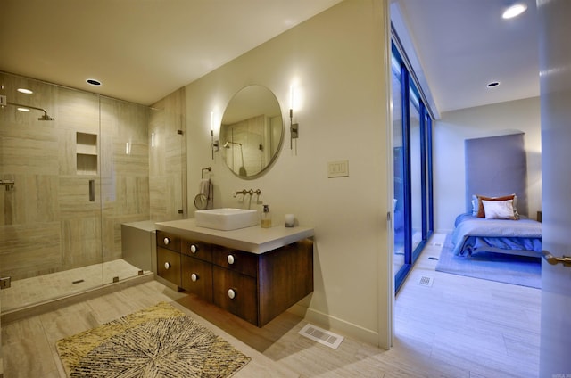 bathroom featuring vanity and an enclosed shower