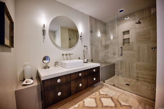 bathroom featuring vanity and an enclosed shower